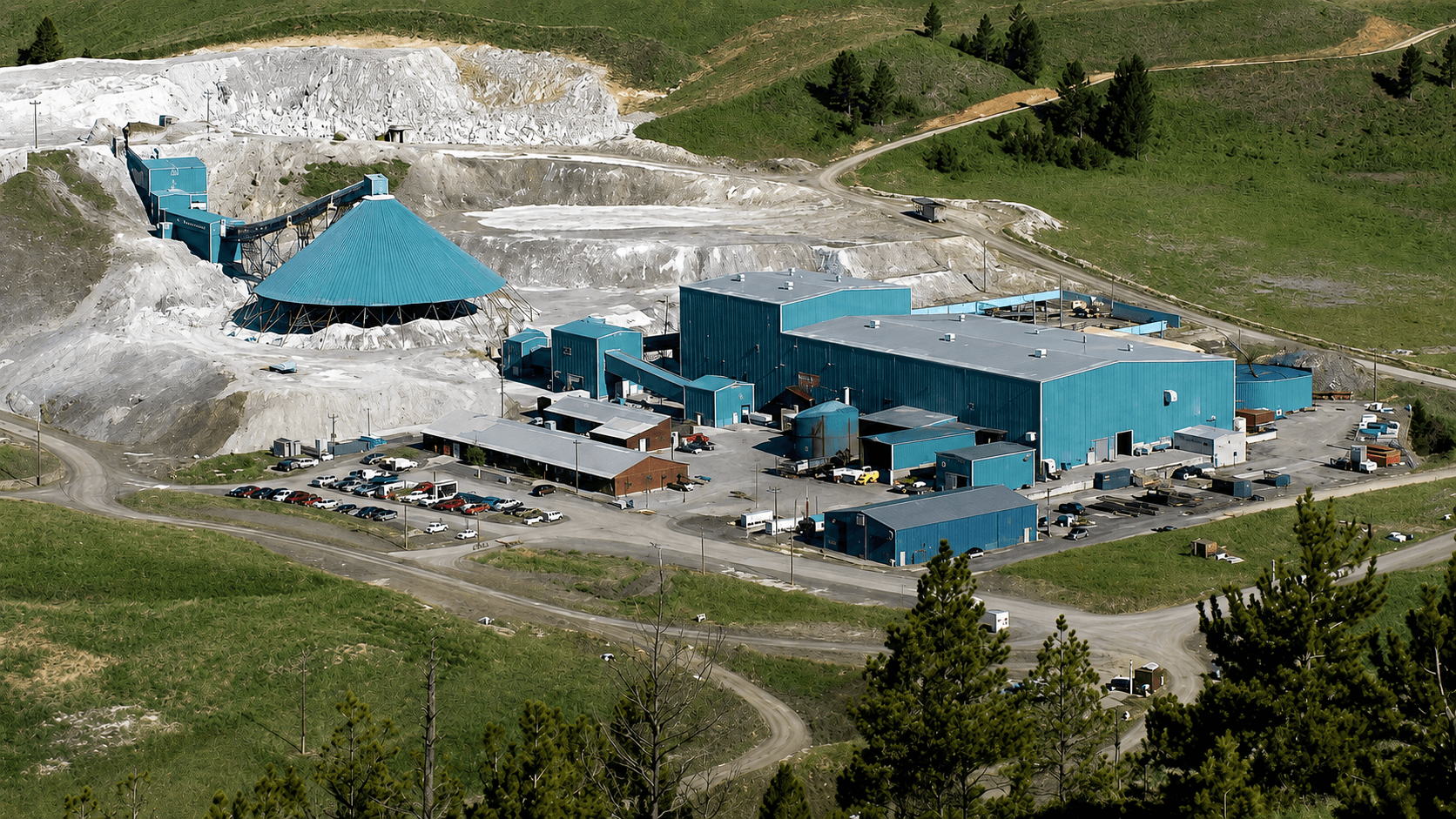 The Jefferson County Metallurgical Complex from above, showing the plant buildings, conveyor, stockpiles and access roads in the surrounding hills