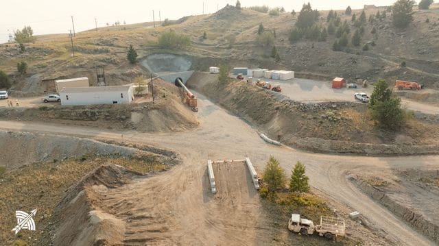 Aerial view of the portal area, truck and stacked steel alongside the road