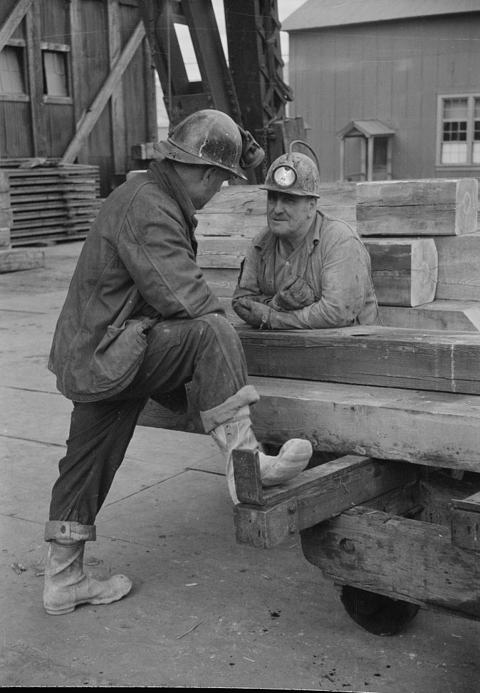 Two copper miners talking in a Butte mine yard, 1939