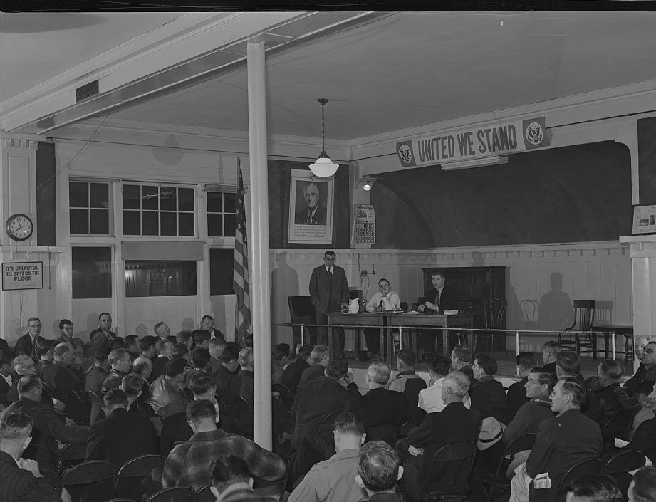 A crowded Butte miners’ union meeting beneath a United We Stand banner, October 1942